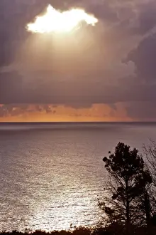 Evening Prints: Thunderstorm parting clouds leaving room for a sunbeam breaking through Adriatic coast