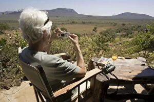 Images Dated 23rd February 2006: Tourist - photographing scenery from veranda at