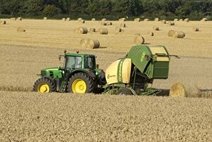 Images Dated 15th September 2012: Tractor pulling straw baling machine in field