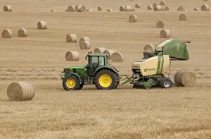 Tractor stopping to allow hay bale making machine to release bale of hay - September - Staffordshire - England