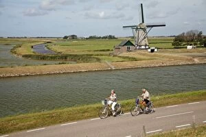 Traditional Windmill - with tourists cycling past
