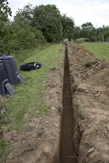 Commercial Prints: Trench dug out in field to carry electric cable ducting - Cotswolds - UK