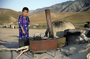 Behind Gallery: Turkmen girl - in traditional dress - boils water