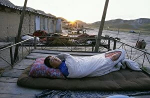 Beds Gallery: Turmen - a family sleeps outside on plank-beds - sunrise