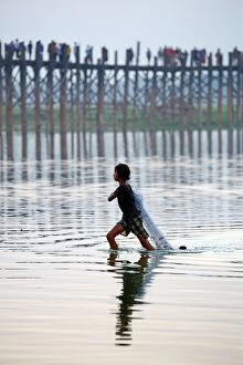 Burma Gallery: The U Bein Bridge with a fisherman walking across the Ta