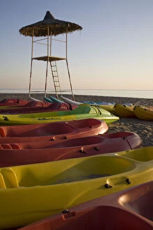 UAE, Fujairah. Colorful kayaks on beach