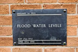 Wall Prints: UK - Brass plate displaying high flood levels on wall of house in Stratford upon Avon