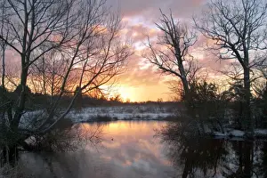 UK - sunrise over a lake on a cold winter morning in January Oxfordshire, England