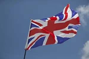 Flags Prints: Union Jack flag - flying in light breeze against blue sky - UK