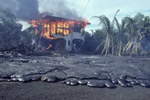 USA - Hawaii - Big Island - Eruption of the Pu'u O'o Vent - a vent of the Kilauea Volcano - in the village of Kalapana Gardens a house surrounded by lava erupts in flames
