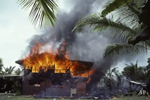 USA - Hawaii - Big Island - Eruption of the Pu'u O'o Vent - a vent of the Kilauea Volcano - in the village of Kalapana Gardens a house surrounded by lava erupts in flames