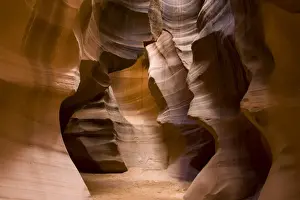 USA - Light that penetrates into the narrow canyon walls creates beautiful hues on the graceful curves of sandstone rock in the Upper Antelope Canyon, probably the most famous slot canyon in the Southwest. Antelope Canyon