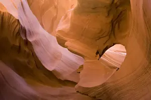 USA - Light that penetrates into the narrow canyon walls creates beautiful hues on the graceful curves of sandstone rock in the Lower Antelope Canyon, probably the most famous slot canyon in the Southwest. Antelope Canyon