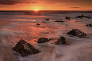 Images Dated 1st June 2021: USA, New Jersey, Cape May National Seashore. Sunrise on rocky shore and ocean. Date: 28-12-2020