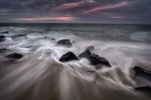 Images Dated 1st June 2021: USA, New Jersey, Cape May National Seashore. Sunrise on rocky shore and ocean. Date: 12-12-2020