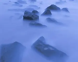 USA, New Jersey, Cape May National Seashore. Sunrise mist on rocky shore. Date: 18-09-2021