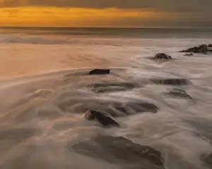 USA, New Jersey, Cape May National Seashore. Sunrise on rocky shoreline. Date: 18-09-2021