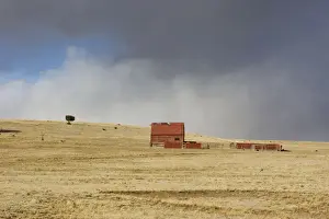 Storms Prints: USA - old barn on New Mexico Prairie with approaching storm. New Mexico in January