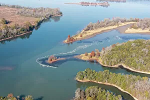 Valley Collection: USA, Tennessee. White pelicans curve around islet Tennessee River