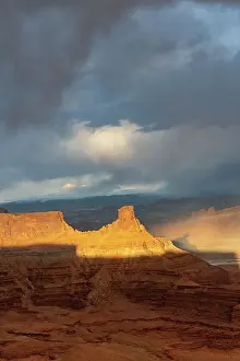 Dead Prints: USA, Utah. Sunset light breaking through desert storm clouds