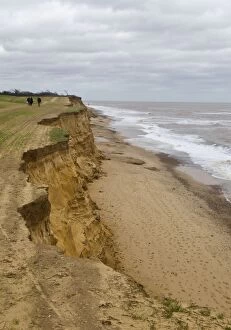 Walkers along the edge of Cliff erosion