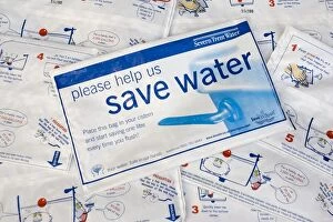 Images Dated 26th May 2007: Water conservation - placing water hippo saveaflush bags, provided free by Severn Trent Water