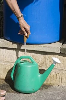Images Dated 29th July 2006: Water conservation - woman filling watering can