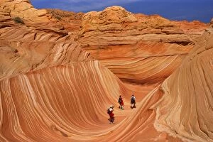 The Wave - with hikers - carved rock eroded into