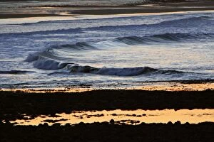 Waves - rolling on to beach at twilight