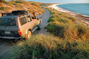 Road Prints: Western Australia - well-equipped 4WD vehicle driving over rough track towards the beach at Warroora Station