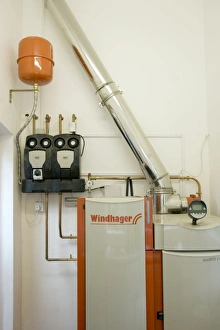 Images Dated 31st August 2007: Windhager Austrian wood pellet fired domestic biomass boiler produces heat for thermal store using