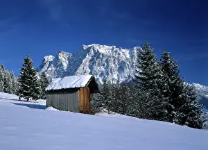 Huts Prints: Winter scenery hut and Zugspitze mountain in winter seen from the village of Erwald Erwald