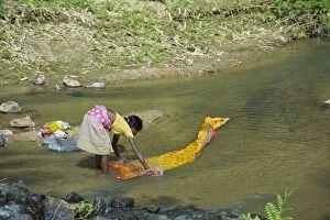 Images Dated 10th November 2010: Woman washing clothes in river