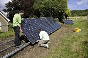 Workers installing solar PV / photovoltaic panels