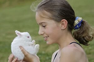 Images Dated 22nd June 2006: Young Girl - holding white Polish rabbit with red eyes