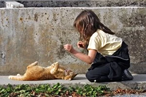 Images Dated 3rd October 2004: Young Girl - playing / teasing ginger tabby cat