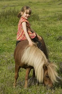 Young girl riding Shetland Pony