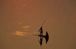Zambia - Fishermen at sunset on the Luangwa river. South Luangwa National Park, Zambia