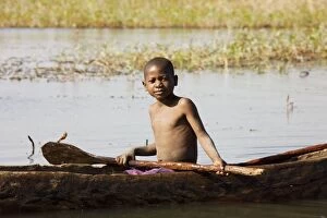 Zambia - Tonga boy in a fishing boat at the shore